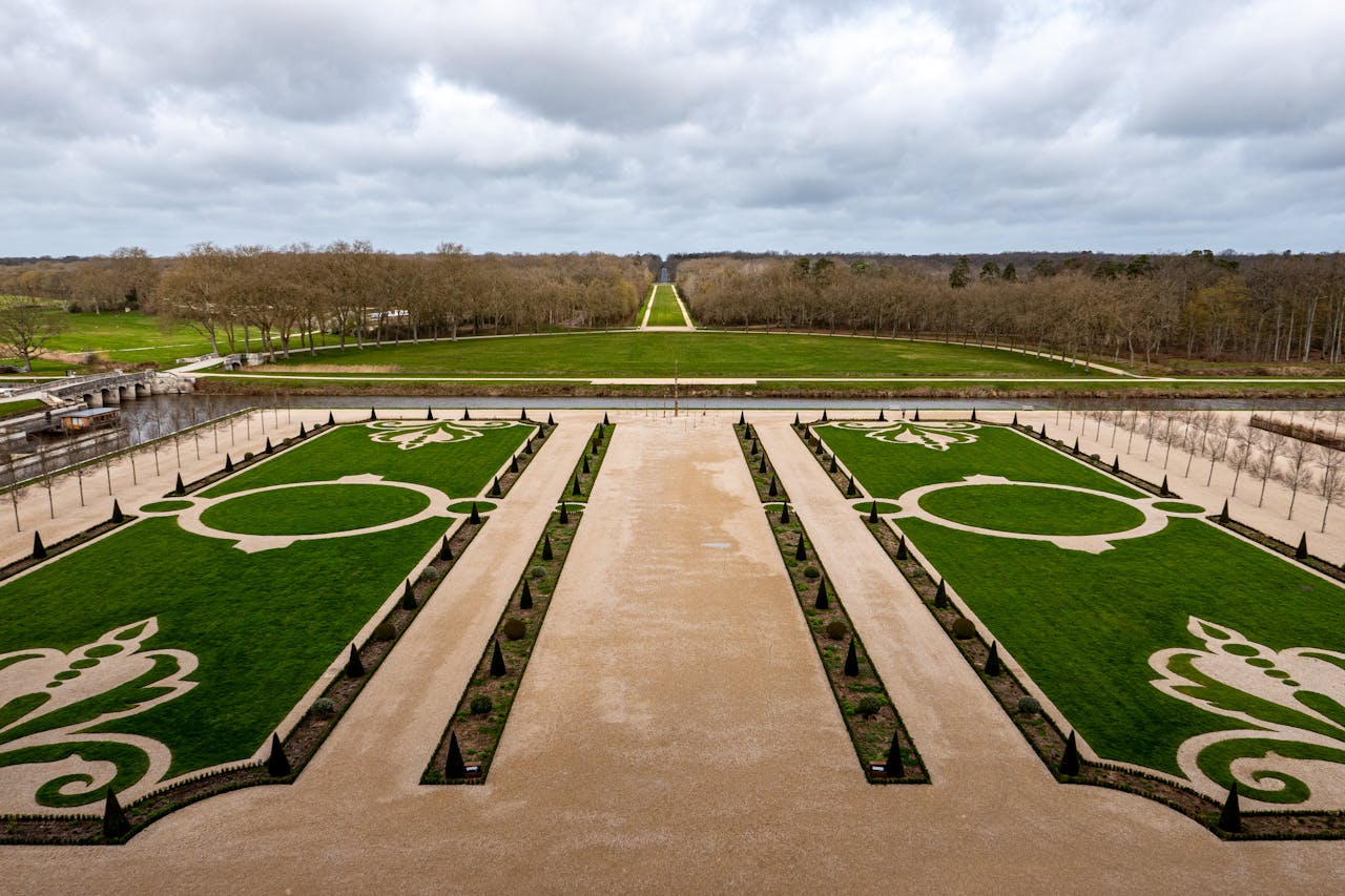 Aerial view of the formal gardens at Château de Chambord in France showcasing symmetrical design and historic beauty.